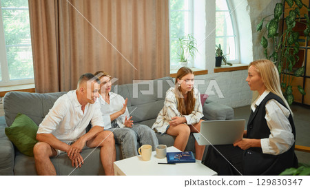 Psychologist guiding family with teenage daughter during consultation Psychologist guiding family with teenage daughter during consultation 129830347
