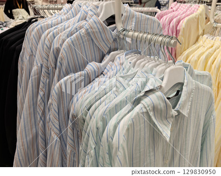 Colorful shirts neatly displayed in a retail clothing store Colorful shirts neatly displayed in a retail clothing store 129830950