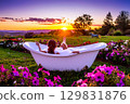 a woman immersed in a bathtub in a flowery meadow 129831876