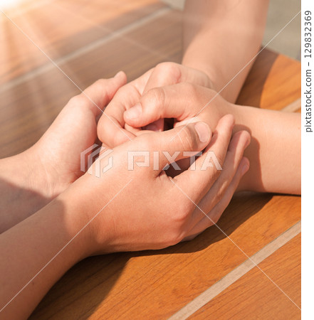 Close-up view of comforting hands Close-up view of comforting hands 129832369
