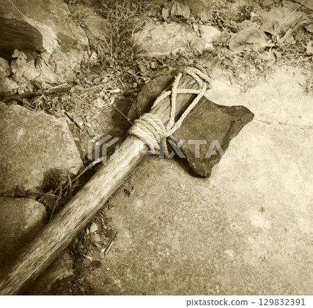 Stone ax of a primitive man 129832391