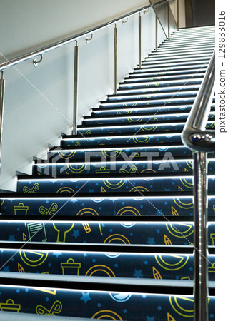 Illuminated stairs with modern design, featuring creative patterns. The glowing effect emphasizes depth, creating sense of movement and future forward architecture Illuminated stairs with modern design, featuring creative patterns. The glowing effect emphasizes depth, creating sense of movement and future forward architecture 129833016