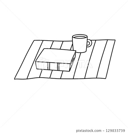 A book and a mug are on a table A book and a mug are on a table 129833739