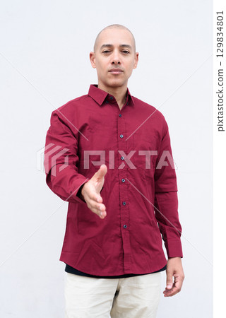 Portrait of bald man in burgundy shirt isolated on white background studio look 129834801