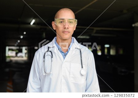 Bald Male Scientist Standing Outside Modern Research Facility Bald Male Scientist Standing Outside Modern Research Facility 129835072