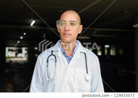 Bald Male Scientist Standing Outside Modern Research Facility Bald Male Scientist Standing Outside Modern Research Facility 129835073