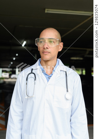 Bald Male Scientist Standing Outside Modern Research Facility Bald Male Scientist Standing Outside Modern Research Facility 129835074