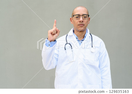 Hispanic Male Doctor in Lab Coat with Stethoscope on Plain Background Hispanic Male Doctor in Lab Coat with Stethoscope on Plain Background 129835163