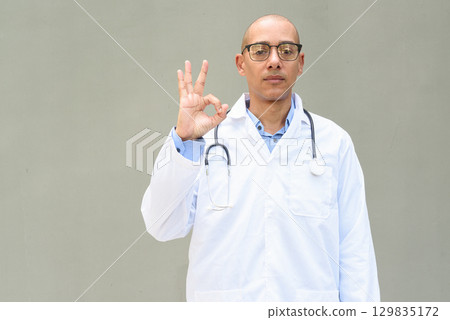 Hispanic Male Doctor in Lab Coat with Stethoscope on Plain Background Hispanic Male Doctor in Lab Coat with Stethoscope on Plain Background 129835172