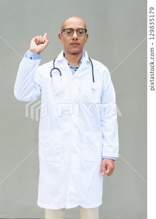 Hispanic Male Doctor in Lab Coat with Stethoscope on Plain Background Hispanic Male Doctor in Lab Coat with Stethoscope on Plain Background 129835179