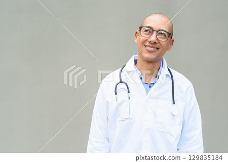 Hispanic Male Doctor in Lab Coat with Stethoscope on Plain Background Hispanic Male Doctor in Lab Coat with Stethoscope on Plain Background 129835184