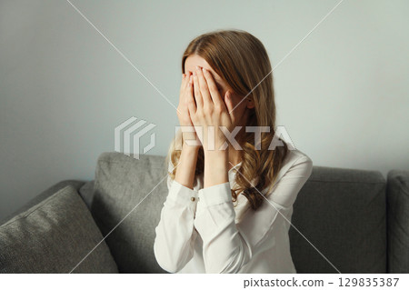 Upset sad crying woman while experiencing mental suffering, depression, fatigue, emotional stress 129835387