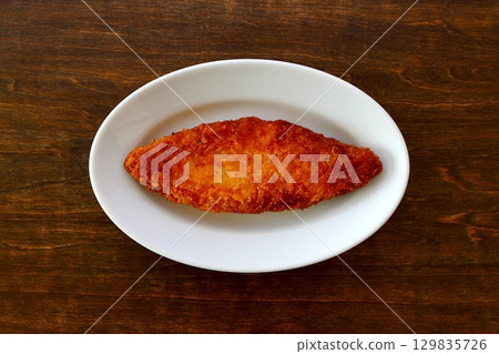Fried white fish on a table background viewed from directly above 129835726