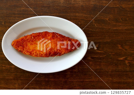 Fried white fish on a table background viewed from directly above Fried white fish on a table background viewed from directly above 129835727