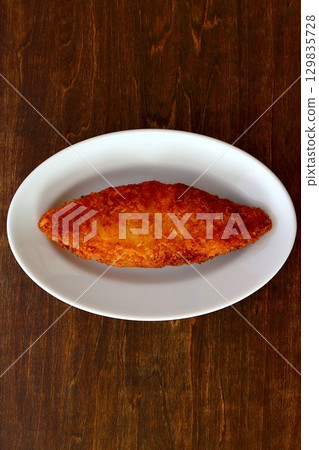 Fried white fish on a table background viewed from directly above Fried white fish on a table background viewed from directly above 129835728