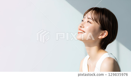 Natural light portrait of a young woman with short hair 129835976