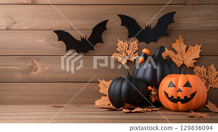 Festive Halloween DIY Pumpkins surrounded by autumn leaves and paper bats, The  background provides a simple backdrop 129836094