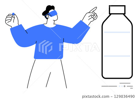 Man in VR headset pointing and holding a small object, interacting with a large bottle. Ideal for VR experiences, product design, technology, innovation, gaming, virtual education, digital 129836490