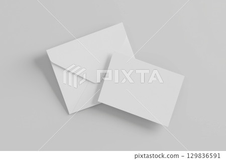 White envelope partially overlapping blank card, resting on minimalist gray surface, creating elegant stationery mockup with clean professional design 129836591
