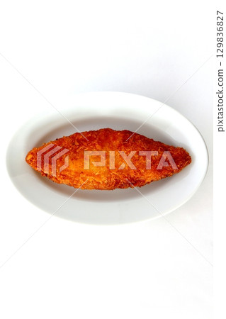 Fried white fish on a white background viewed from directly above 129836827