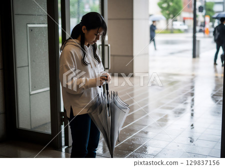 Lifestyle of a woman with an umbrella on a rainy day 129837156