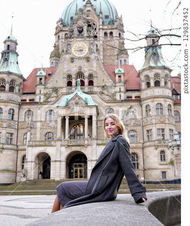 Woman sitting near historic building 129837452