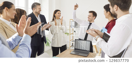 Group of happy young successful business people applauding making a good deal in office 129837770