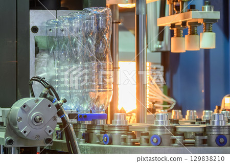 The drinking water bottle manufacturing process by blow mold machine. 129838210