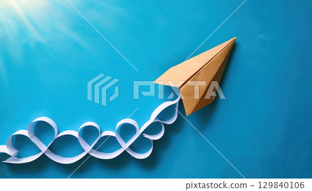 paper airplane soaring through bright blue sky, symbolizing creativity and innovation 129840106