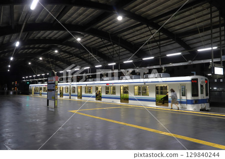 Tobu Daishi Line 8000 series train parked at Daishimae Station at night 129840244