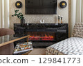 Modern Fireplace with Black Marble Surround in Cozy Room 129841773