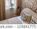 Stylish Bedroom Details with Embossed Wall and Pillows 129841775