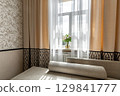 Beige Curtains and Flower Vase by Window in Cozy Room 129841777