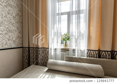 Beige Curtains and Flower Vase by Window in Cozy Room 129841777