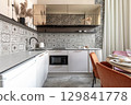 Modern Kitchen with Patterned Tiles and Elegant Dining Area 129841778
