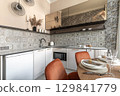 Stylish Kitchen Interior with Patterned Tiles and Dining Setup 129841779