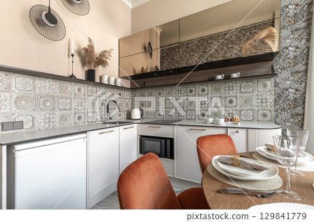 Stylish Kitchen Interior with Patterned Tiles and Dining Setup Stylish Kitchen Interior with Patterned Tiles and Dining Setup 129841779