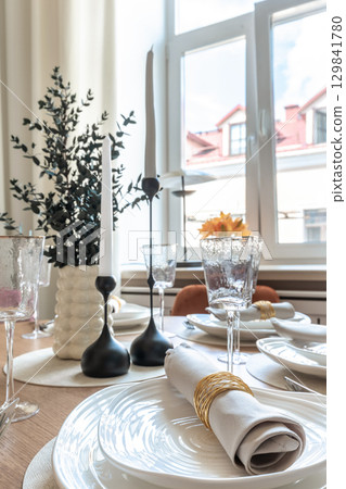 Close-Up of Elegant Table Setting Near Window Close-Up of Elegant Table Setting Near Window 129841780