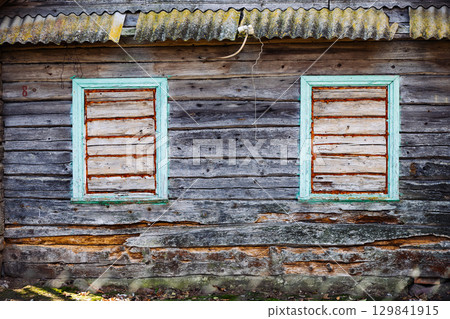Boarded windows of abandoned wooden house showing decay and neglect Boarded windows of abandoned wooden house showing decay and neglect 129841915