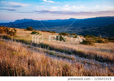 Scenic landscape overlooking Crimean mountains during golden hour Scenic landscape overlooking Crimean mountains during golden hour 129841919
