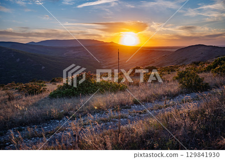 Sunset illuminating Crimean mountains and valleys with colorful sky 129841930