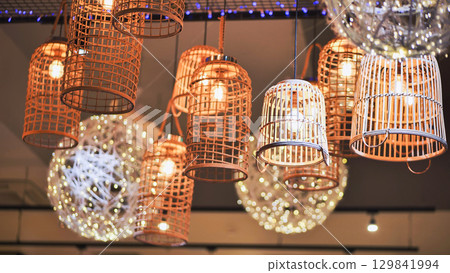 Decorative wicker lamps illuminating a modern interior design 129841994