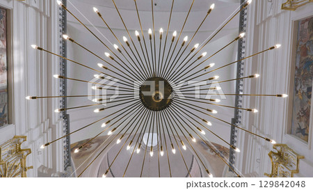 Modern Chandelier Illuminating Church Ceiling with Frescoed Walls Modern Chandelier Illuminating Church Ceiling with Frescoed Walls 129842048