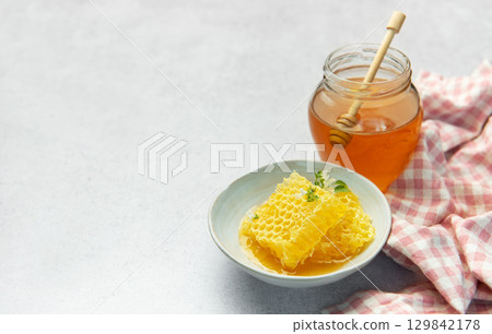Honey, honeycomb and bee pollen creating delicious golden composition Honey, honeycomb and bee pollen creating delicious golden composition 129842178