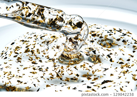 Mouth-watering thick texture of 24k gold serum. Mouth-watering thick texture of 24k gold serum. 129842238