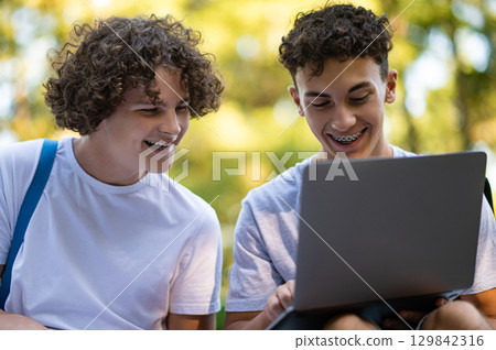 Teens learning lessons and looking involved while reading books 129842316