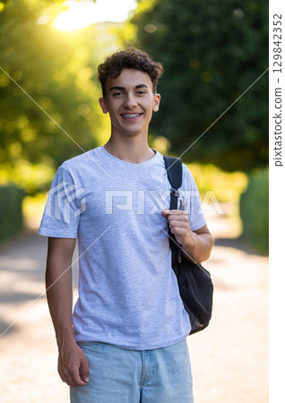 Dark-haired teenager in casual clothes looking good and happy 129842352