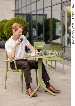 Self-employed male working online submitting card details completing shopping Self-employed male working online submitting card details completing shopping 129842367