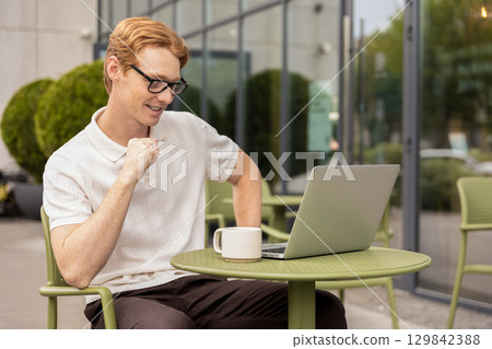 Young Caucasian man opening webcam listening to client talking remotely Young Caucasian man opening webcam listening to client talking remotely 129842388