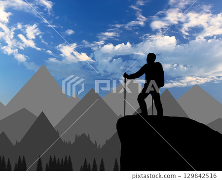 Silhouette of a climber on top looks into the distance over the mountains 129842516